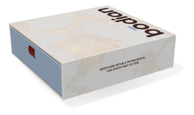 The 4-set drawer box, closed: a sleeve of cream paper printed with pale silk flowers, and the cerulean drawer on its ribbon