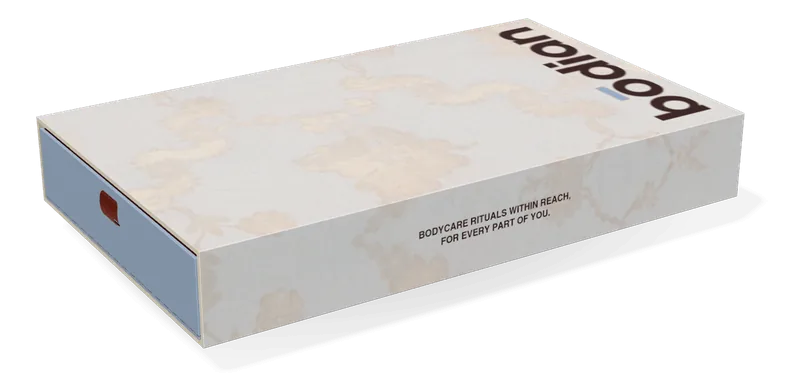 The 10-set drawer box, closed: a sleeve of cream paper printed with pale silk flowers, and the cerulean drawer on its ribbon
